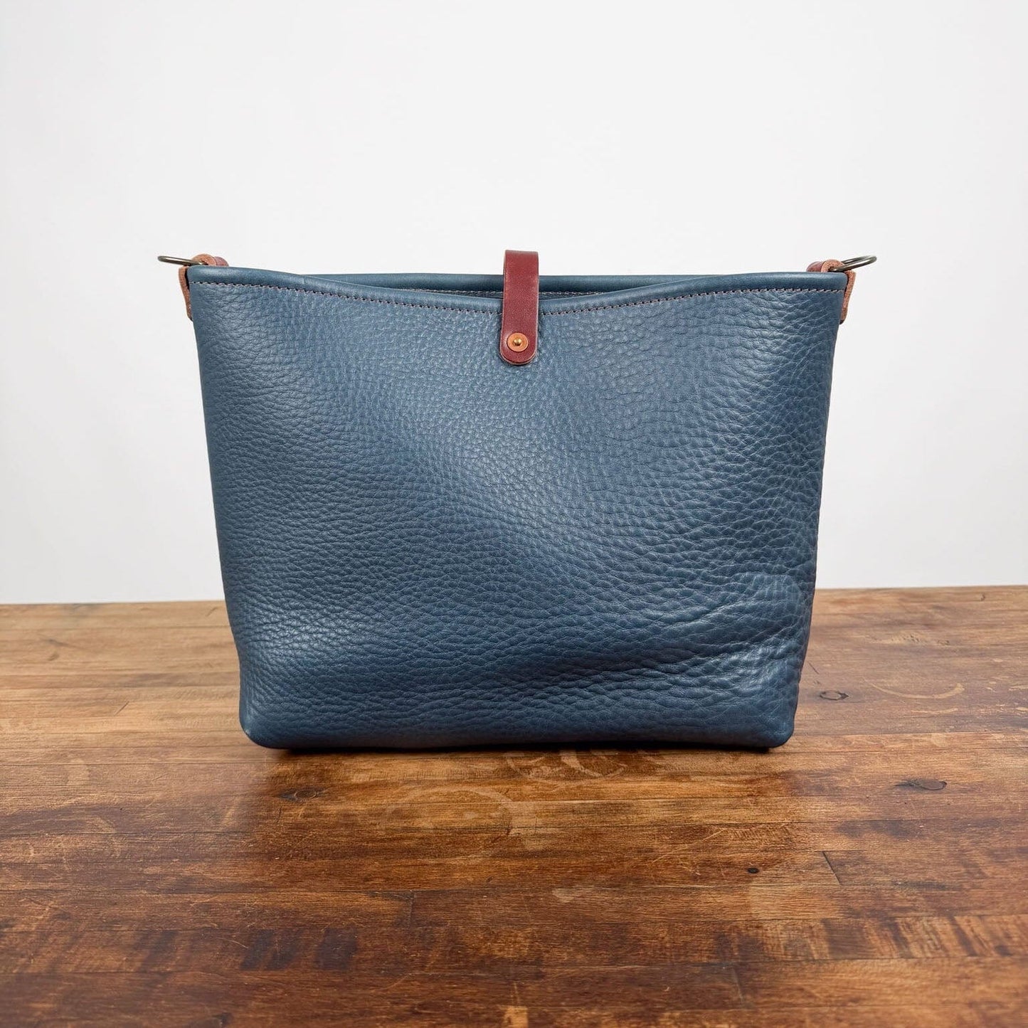 AVERY CROSSBODY - SMALL - SMOKEY BLUE - SADDLE STRAPS - LARGE FRONT POCKET - HEMMED TOP - BUTTON STUD - IN STOCK